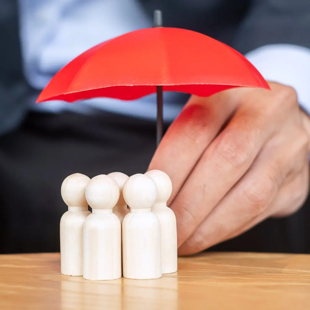 A graphic of fictional figures protected by a red umbrella.