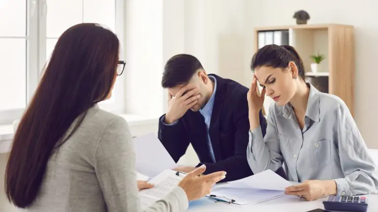 A couple of frustrated people looking at all the bills