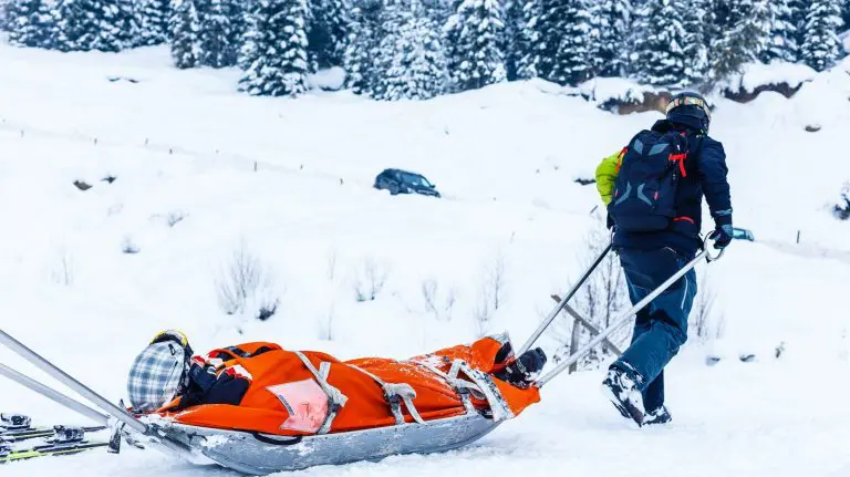 Image of a patient carried by 2 emergency helpers on an Accident on a Ski Trip
