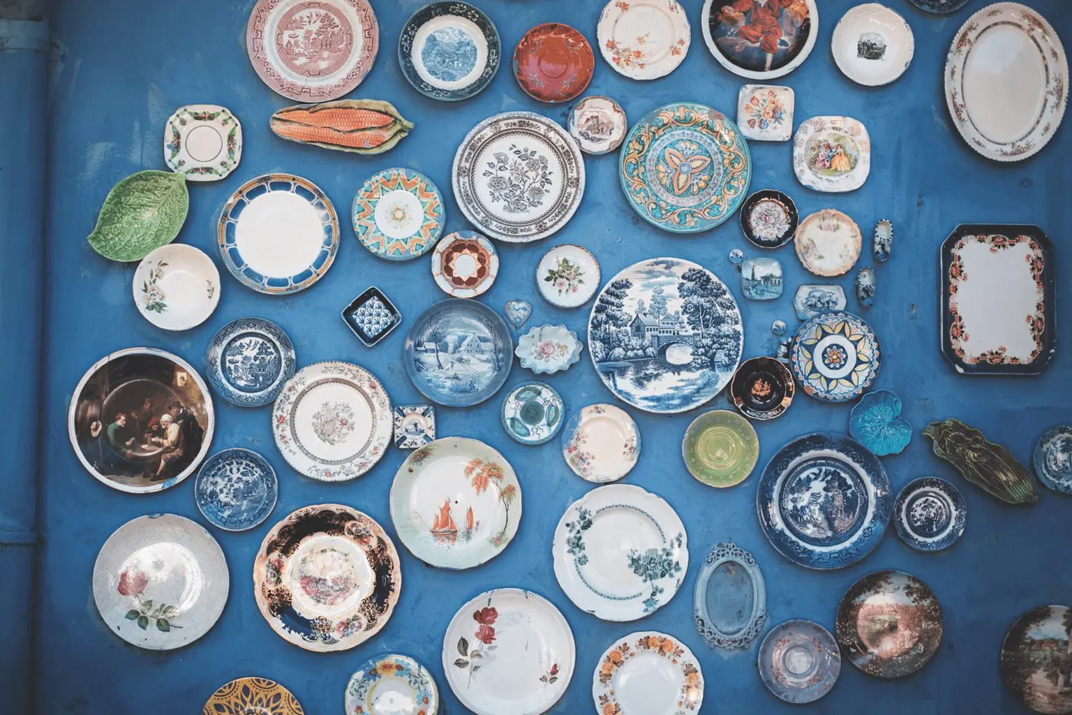 Antique plates hanged on a blue wall