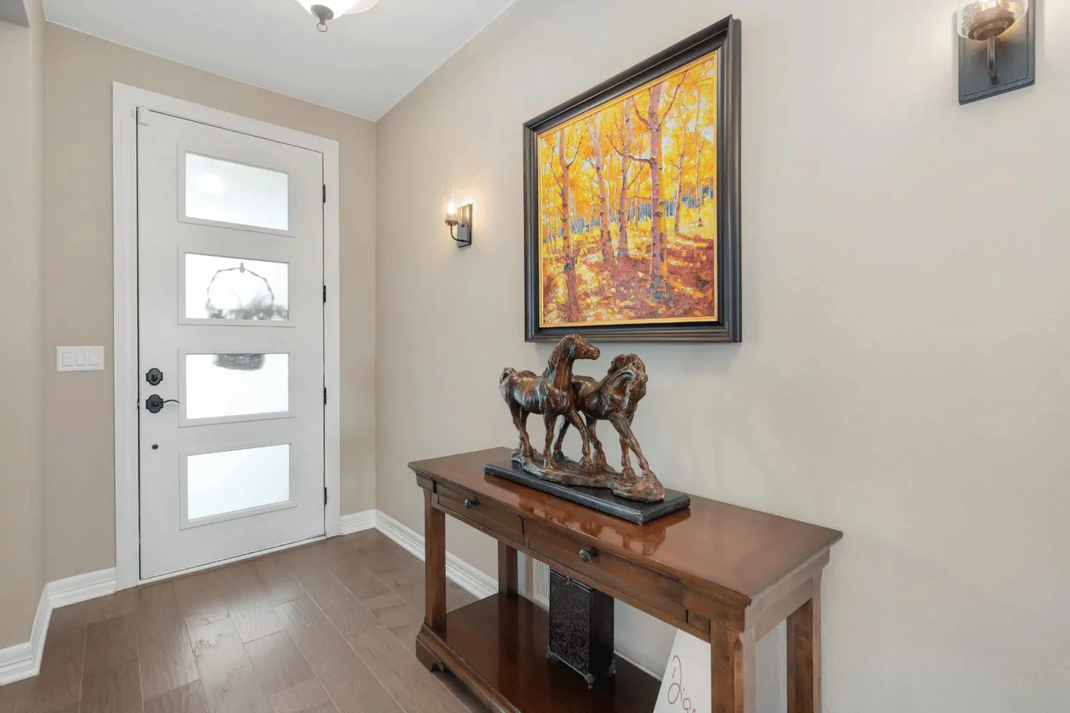 Image of a horse sculpture with a painting in a house entrance