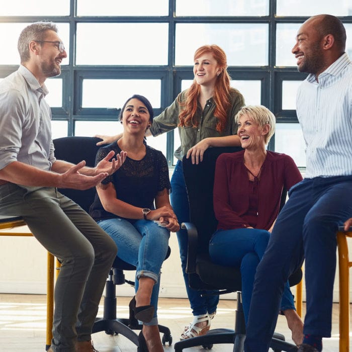 Colleagues having a discussion in the office - Norton Insurance Brokers