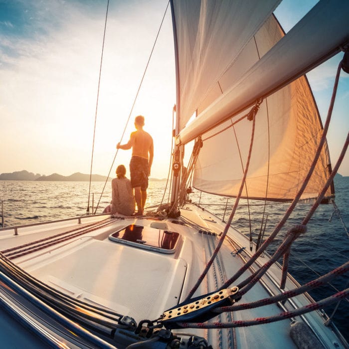 Couple enjoying sunset from the sail boat - Norton Insurance Brokers