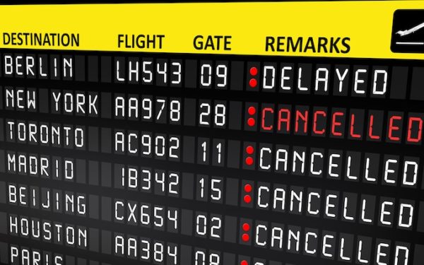 flight board showing delayed and cancelled flights