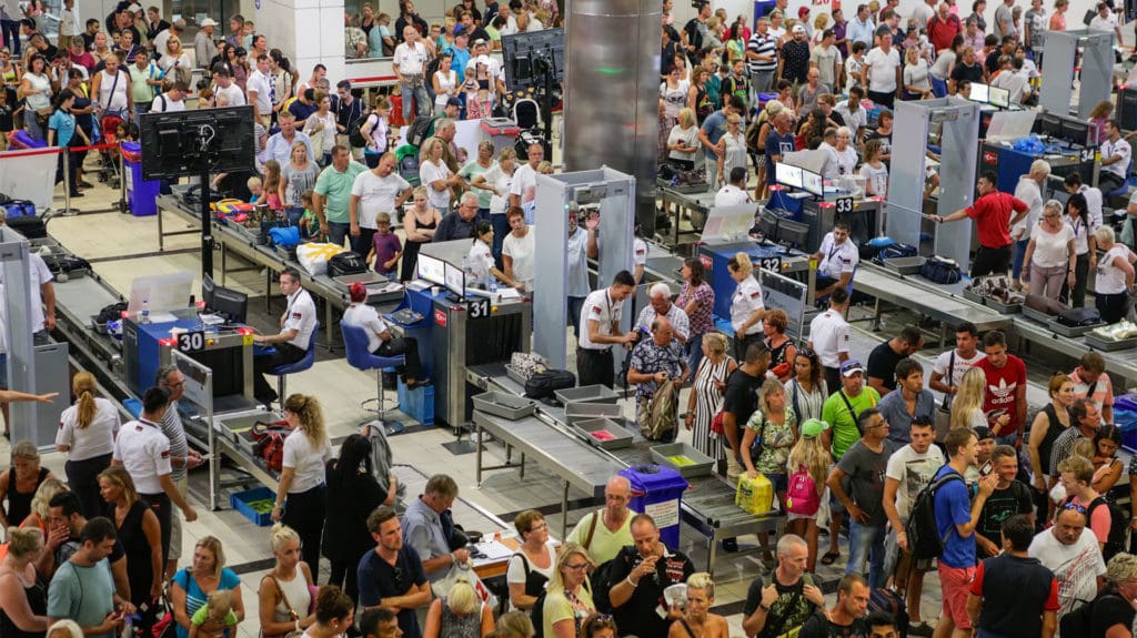 long queues for security at a UK airport 