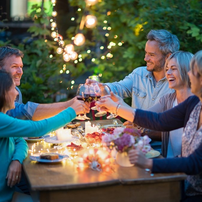 happy friends enjoying an outdoor dinner - Norton Insurance Brokers personal client manager service - protecting the things that matter the most to you