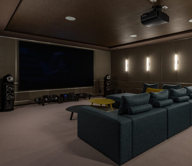 A modern, luxurious home cinema set up with hi-fi systems fitted for surround sounds.