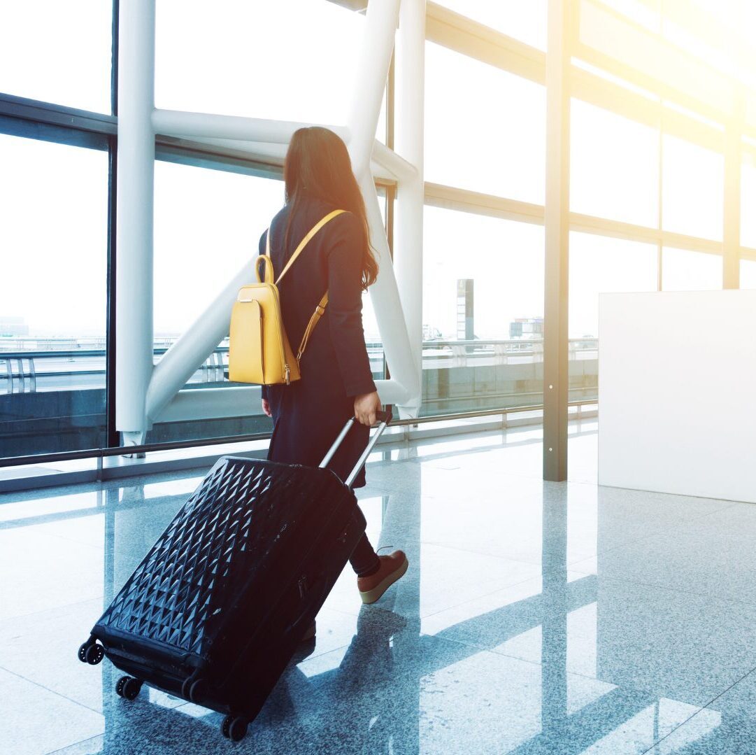A lady in an airport about to board a plane.