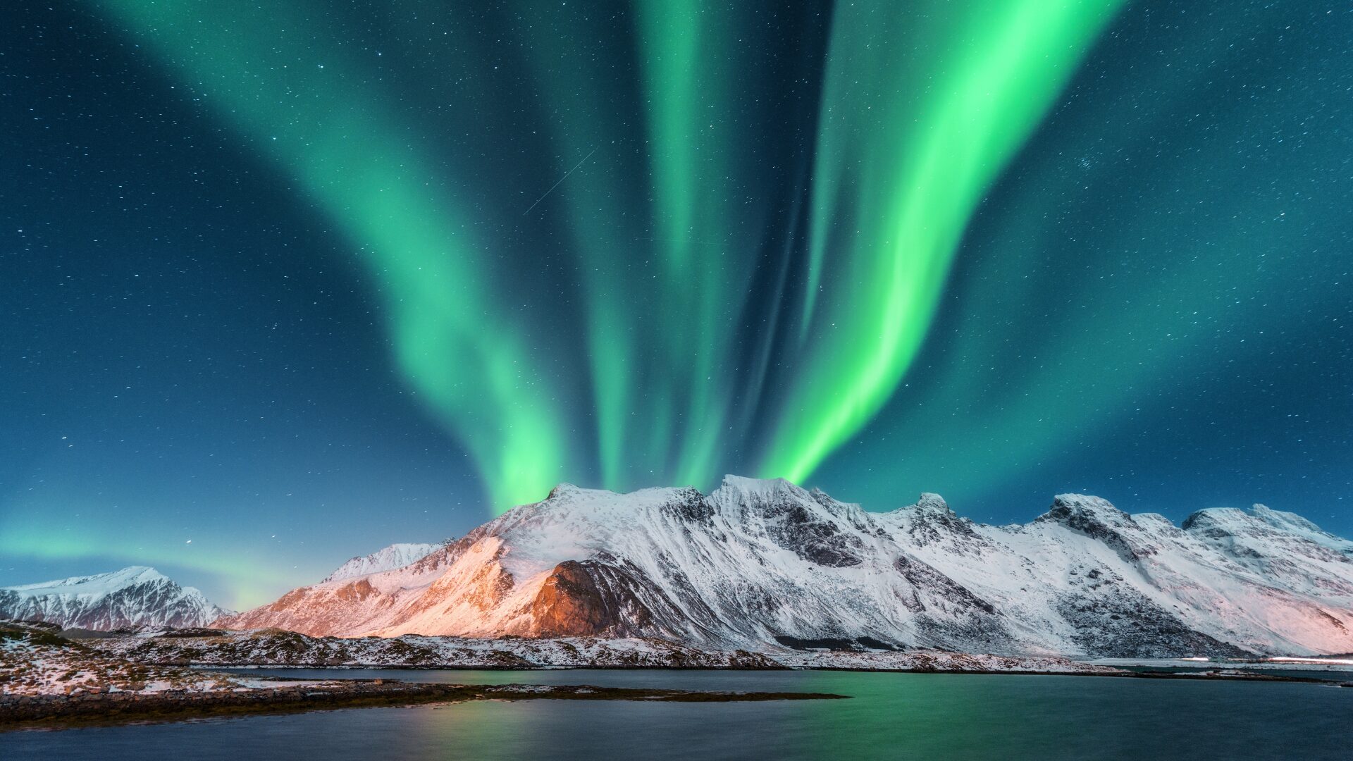 An aerial shot of the Northern Lights in Lofoten Islands, Norway.