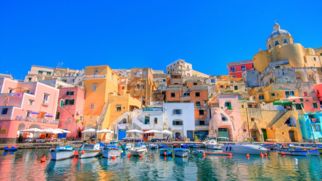 A row of buildings by a marina in Procida, Italy