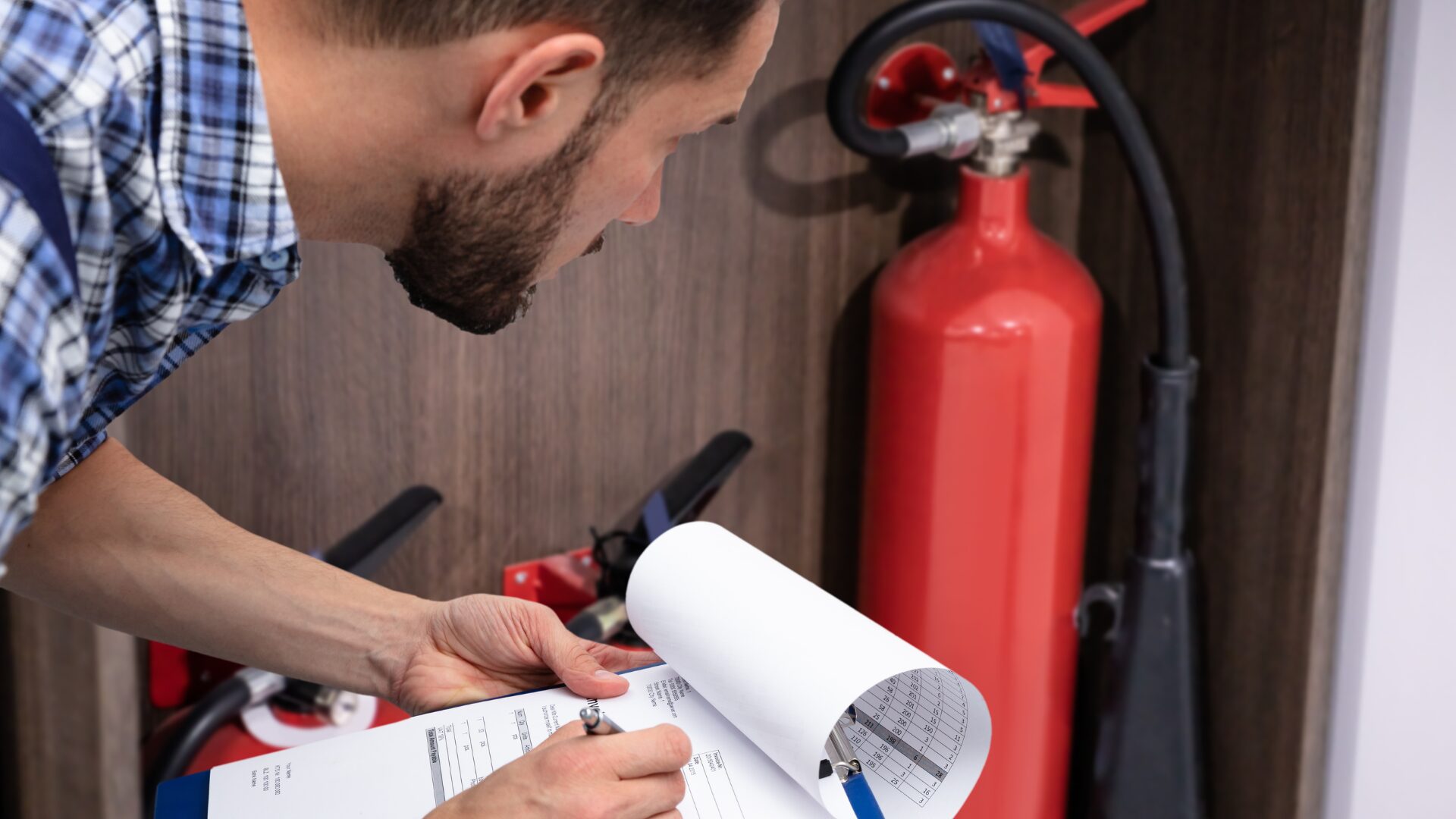 Inspecting a fire extinguisher to test its safety.