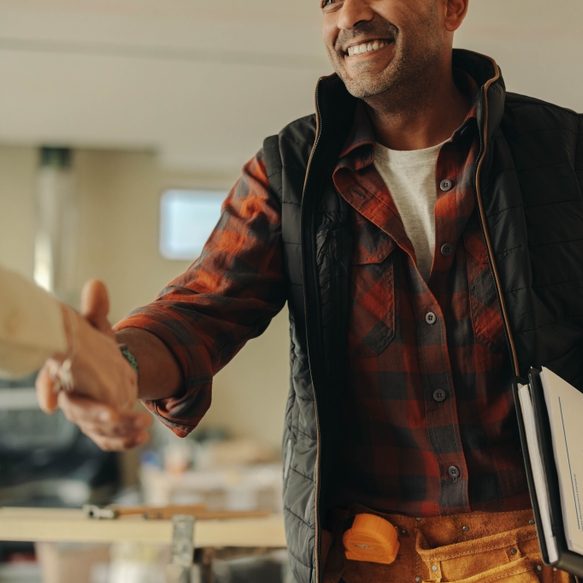 A contractor shaking hands with a client.